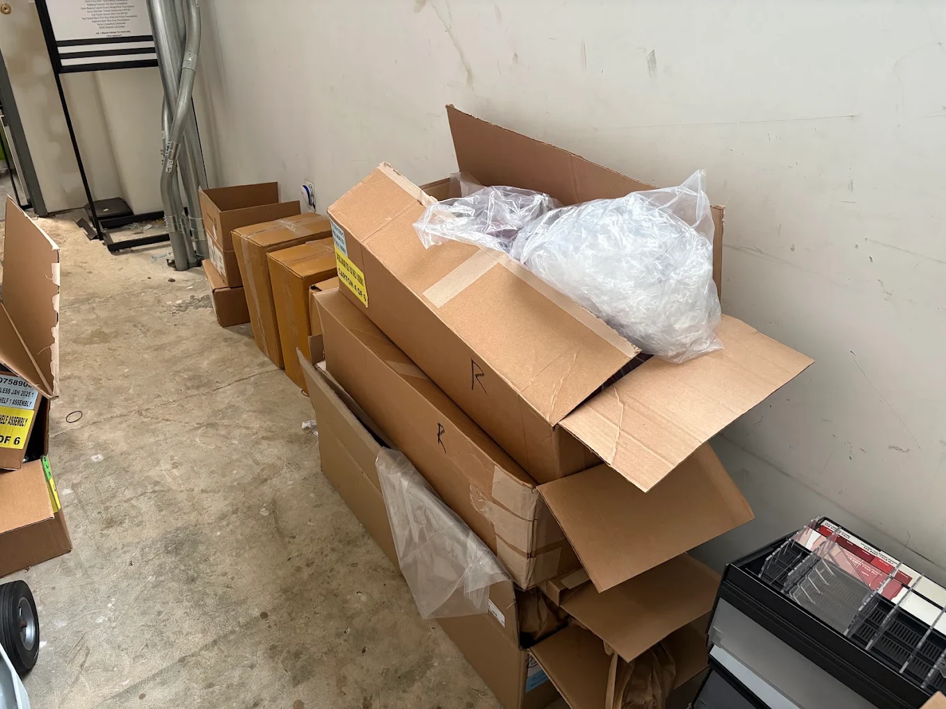 Stacked cardboard cartons and packaging waiting in a commercial back room for cardboard removal