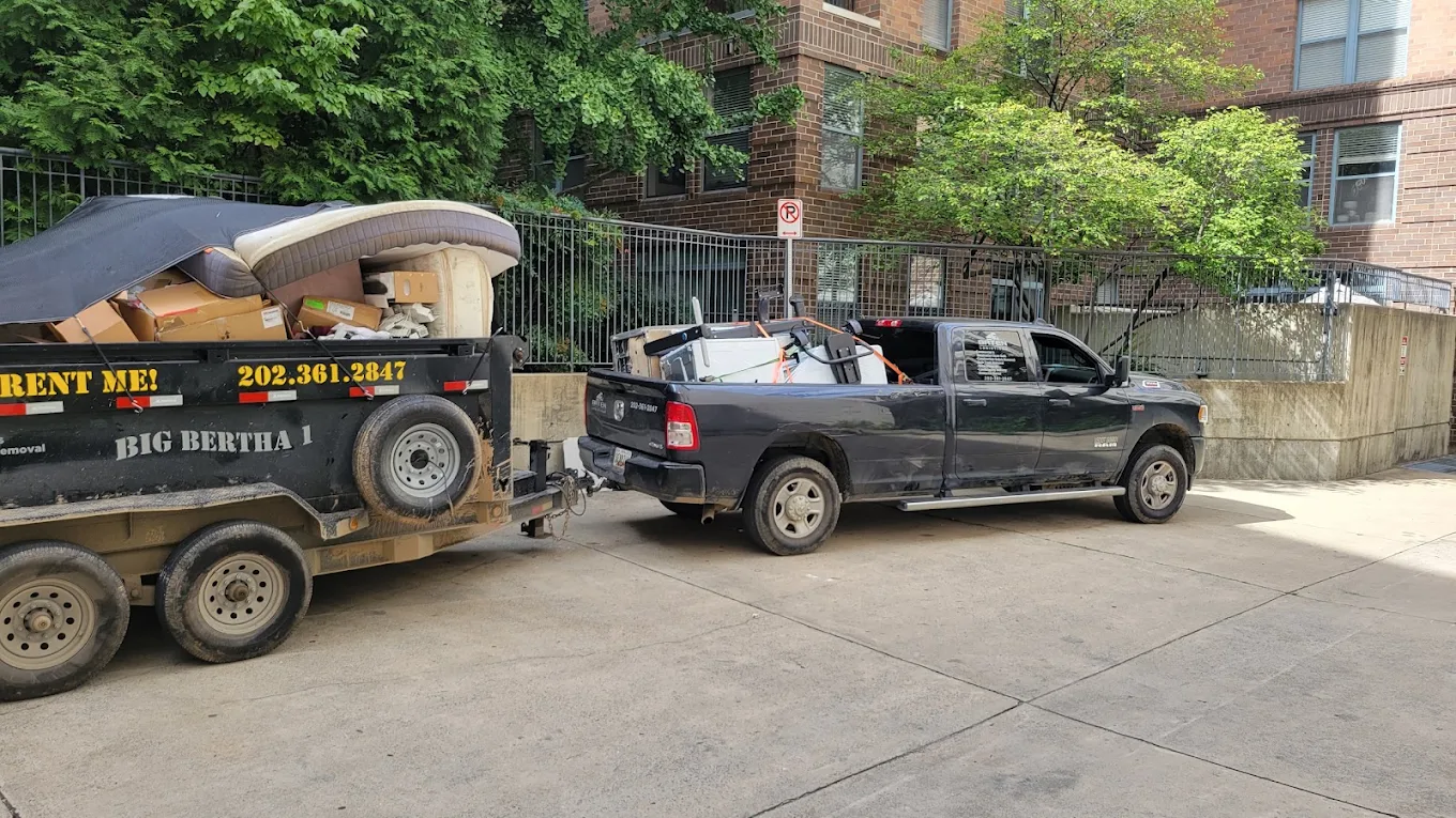 Baten Ram pickup hooked to Big Bertha 1, both loaded, parked outside a DC apartment building