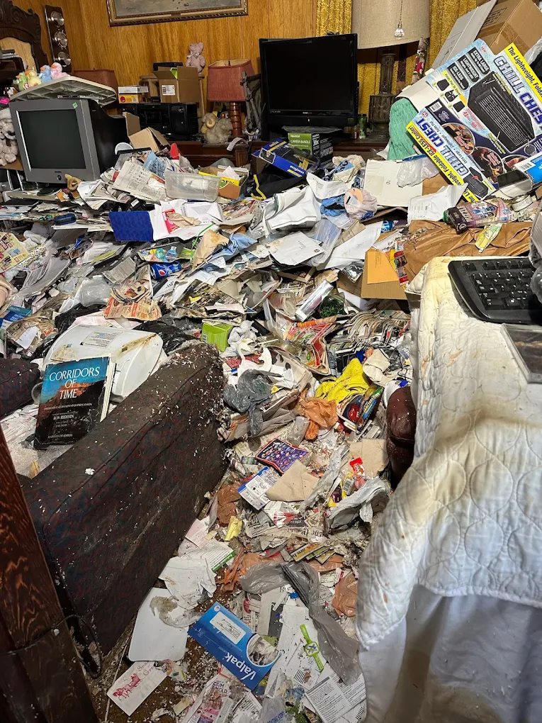 Severely cluttered hoarder home interior before a Baten Hauling cleanout