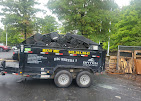 Baten dump trailer loaded to the rails on a rainy driveway job
