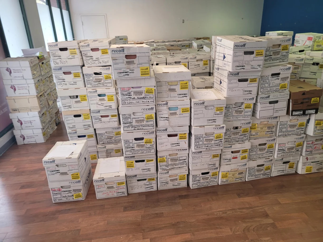 A room wall-to-wall with hundreds of labeled Recall archive record boxes awaiting commercial removal