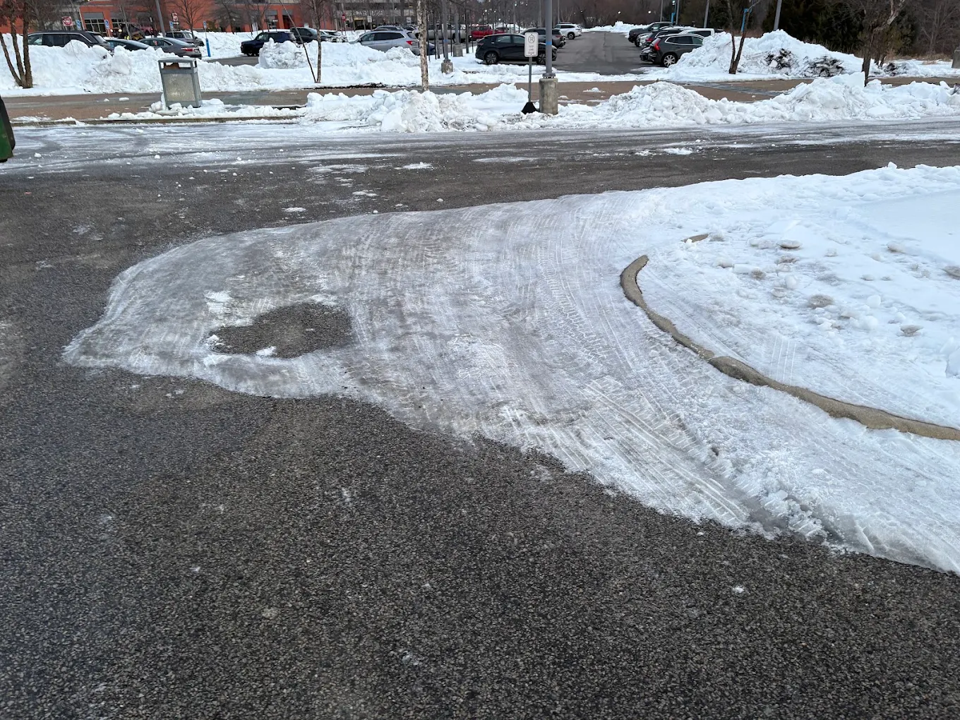 Commercial parking lot plowed down to clean pavement after a DMV snowstorm